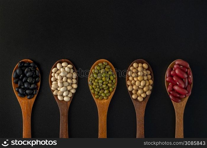 Collection of whole grains seeds isolated on black background. Healthy diet raw ingredients.. Collection of whole grains seeds isolated on black background.