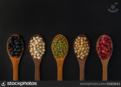 Collection of whole grains seeds isolated on black background. Healthy diet raw ingredients.. Collection of whole grains seeds isolated on black background.