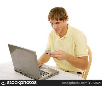 College age young man using a credit card to shop on the internet. Isolated on white.