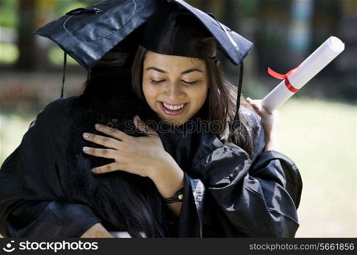 College graduates hugging