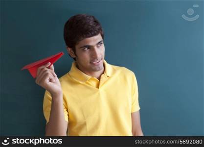 College student with a paper aeroplane