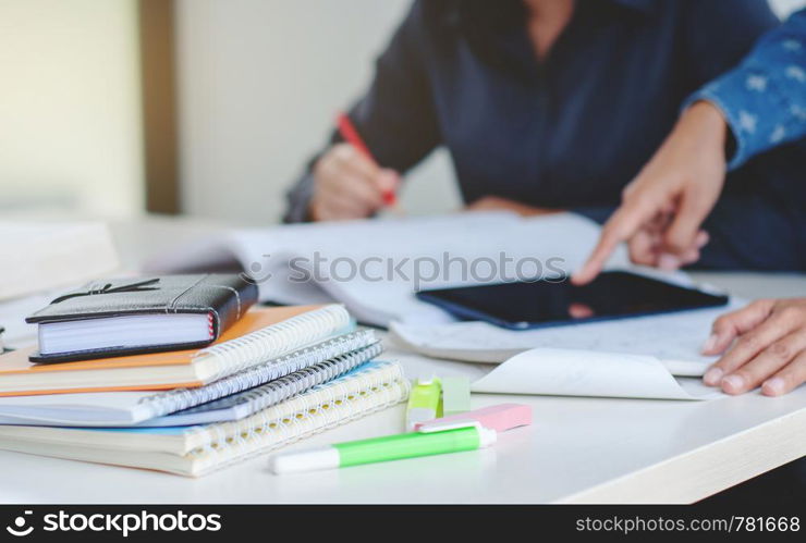 college students classmate doing homework together in library, Selected focus.