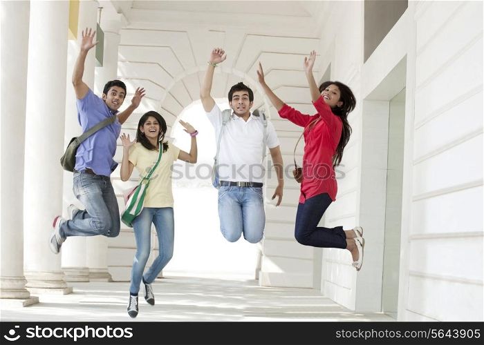 College students jumping in corridor