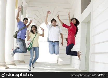 College students jumping in corridor