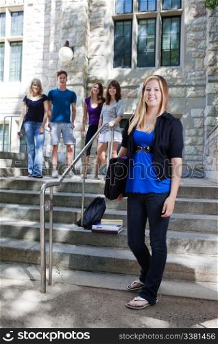 College students on the stairs of college building