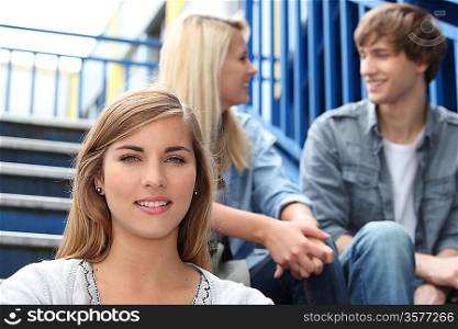 College students sitting on an exterior staircase