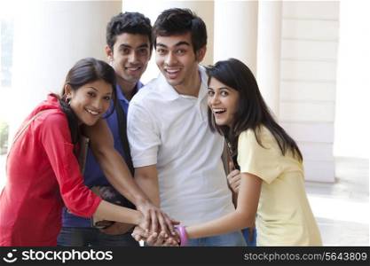 College students stacking their hands