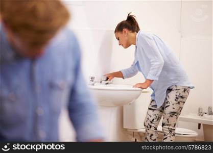 College Students Studying Plumbing Working On Washbasin