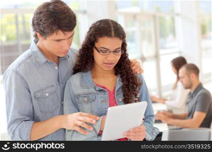 College students using touchpad in hall