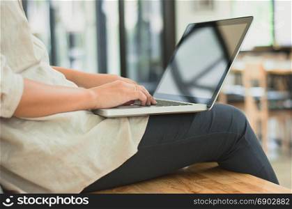 college woman sitting and working on a laptop