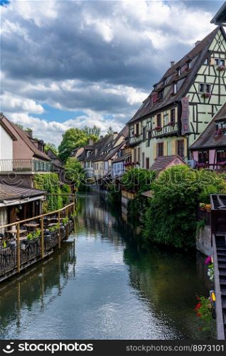 Colmar, France - 29 May, 2022: vertical view of the Little Venice district in historic Colmar with its canals and colorful historic half-timbered houses