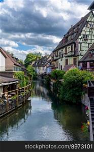 Colmar, France - 29 May, 2022: vertical view of the Little Venice district in historic Colmar with its canals and colorful historic half-timbered houses