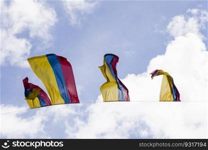 Colobian flags under blue sky in Bogota, Colombia