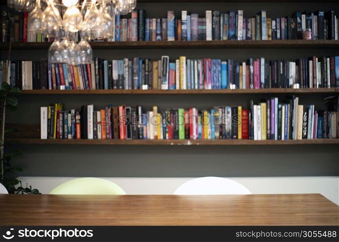 Coloful wall with many books on book shelves in a modern living room blurred, retro interior beauty. Coloful wall with many books on book shelves in a modern living room blurred, retro interior