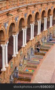 Colonnade and tiled benches of the Plaza de Espana pavilion in Seville, Andalusia, Spain.