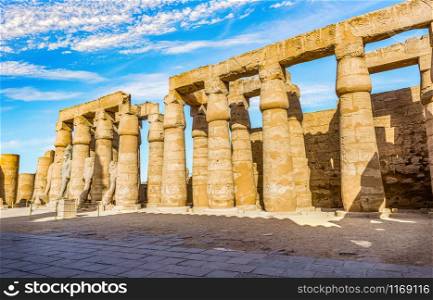 Colonnade in Karnak Temple and blue cloudy sky, Luxor. Colonnade in Karnak Temple