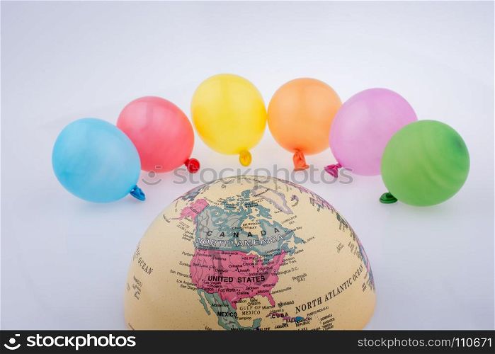 Color balloons are placed around the half a globe