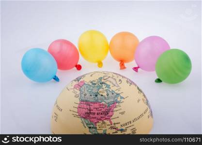 Color balloons are placed around the half a globe