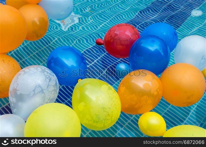 color balloons floating in a pool