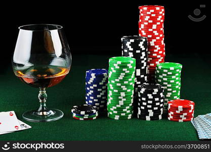 color chips for gamblings, drink and playing cards on green