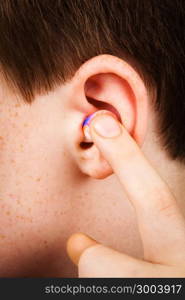 color earplug into the ear close up