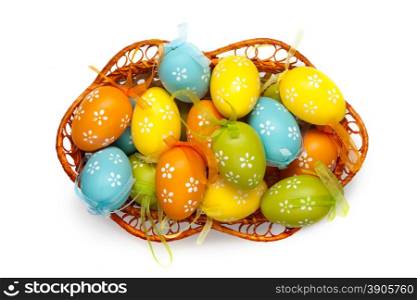 color easter eggs in basket isolated on white. top view