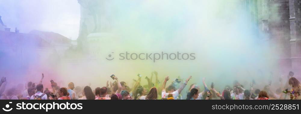 color festival in city crowd celebrating