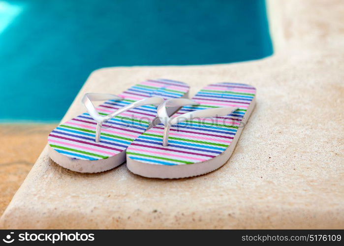 Color flip-flops near to the pool