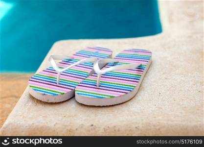 Color flip-flops near to the pool