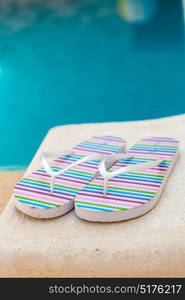 Color flip-flops near to the pool