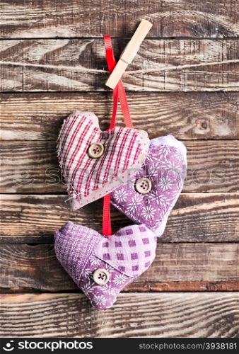 color hearts from textile on wooden background