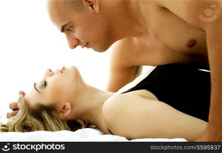 color image of sweet couple cuddling in bed