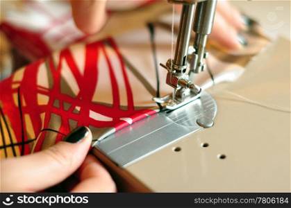 Color Image with Hands of Seamstress Using Sewing Machine