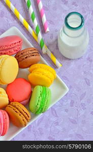 color macaroons and milk on vintage paper background