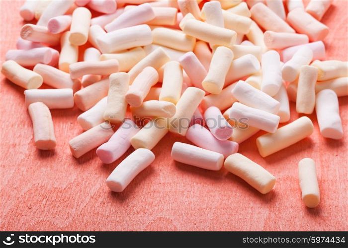 Color marshmallow scattered as a background, close up