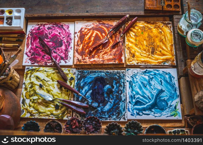 color painter artist&rsquo;s workspace, water color tools on desk of painter.