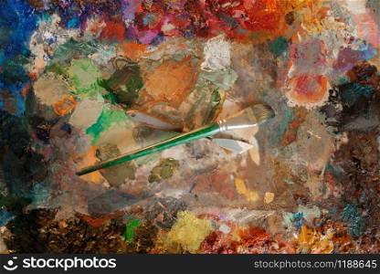 Color palette and brush closeup, nobody, paintbrush art drawing. Artist or painter tools and equipment, painting supplies. Color palette closeup, paintbrush art drawing