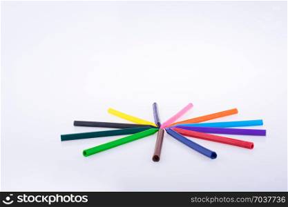 Color pen arranged on a circular form on a white background