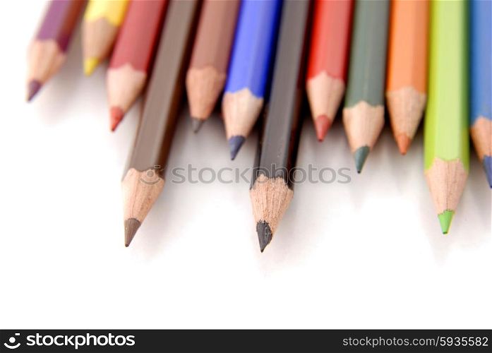 color pencils aligned and isolated on white, focus on the midle one
