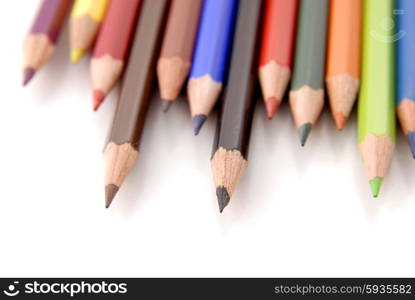 color pencils aligned and isolated on white, focus on the midle one