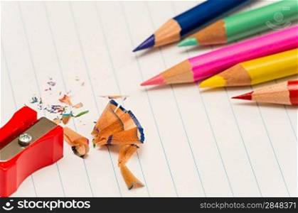 Color pencils and sharpener shaving back to school