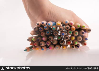 Color pencils. Hand holding Color pencils on a white background