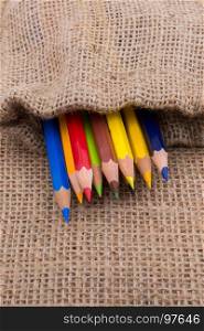 Color Pencils in a linen sack on canvas