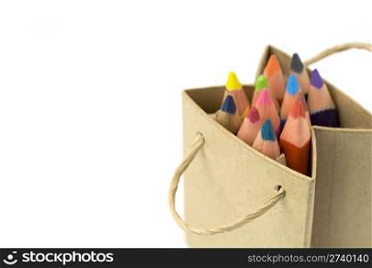 Color pencils in a shopping bag on a white background