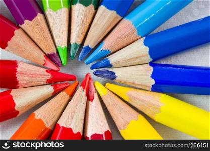 Color pencils in round formation on white background. Shot at extreme close-up