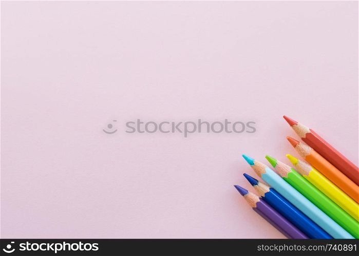 Color pencils on Pink paper background, copy space. Office supplies, back to school. Top view.. Color pencils on Pink background, copy space. Office supplies, back to school.