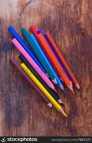 color pencils on the wooden table