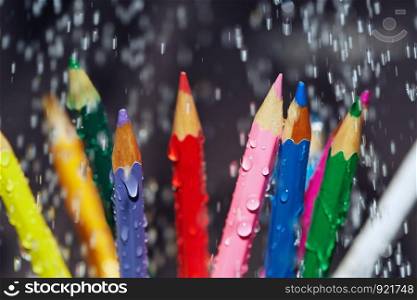 Color pencils under the rain. Close-up view