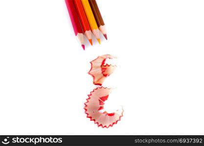color pencils with its shavings on white background