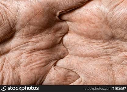 Color photo of senior man hands with crossed fingers